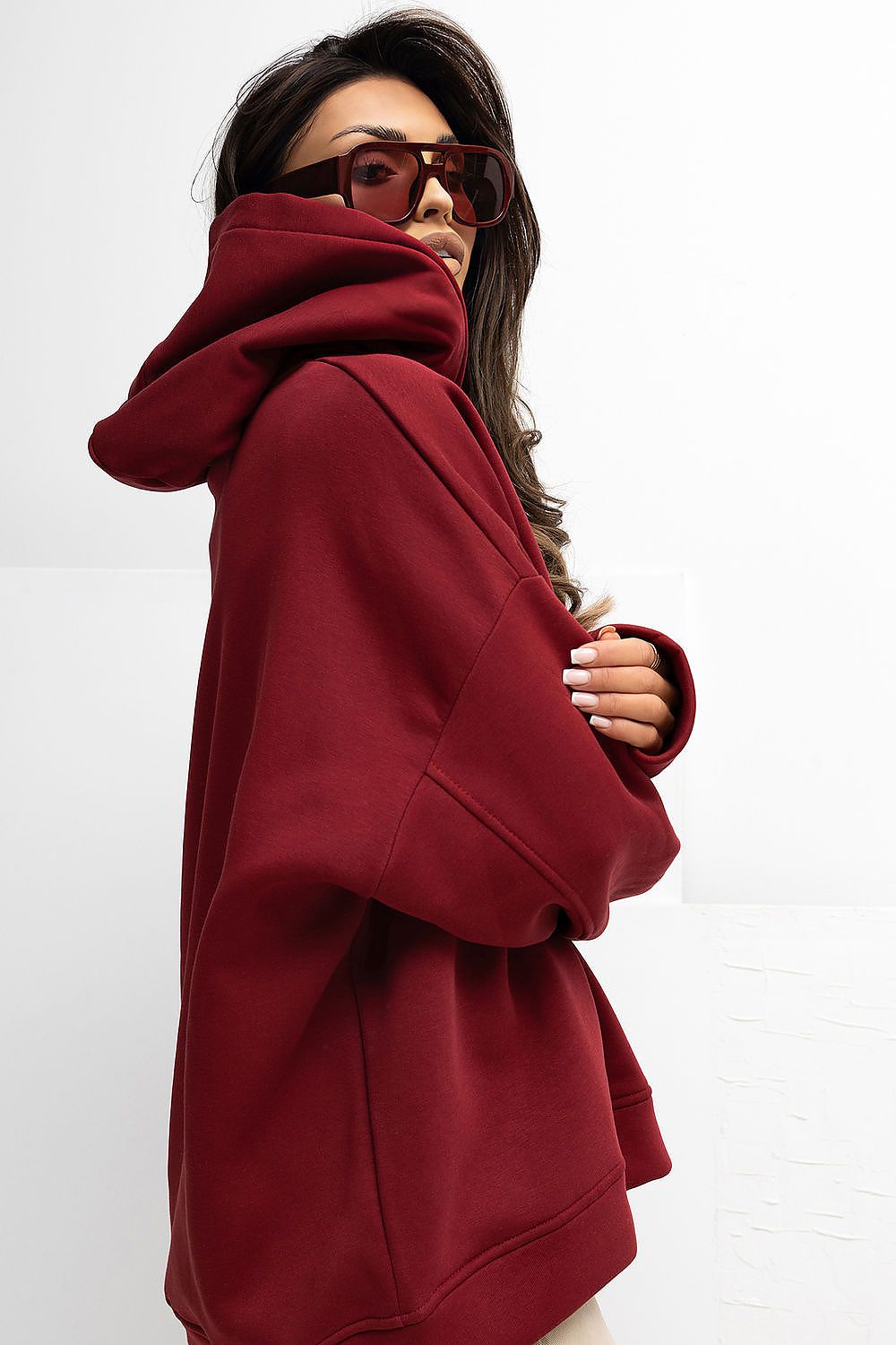 Person wearing a red hoodie on a white background