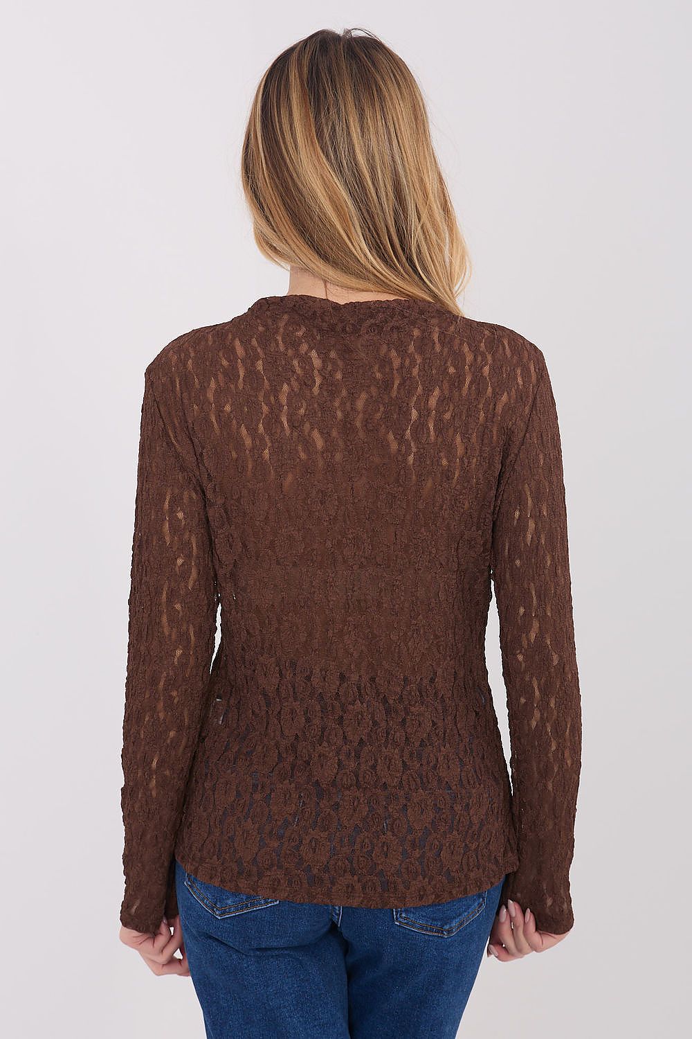 Person wearing a brown patterned sweater on a white background