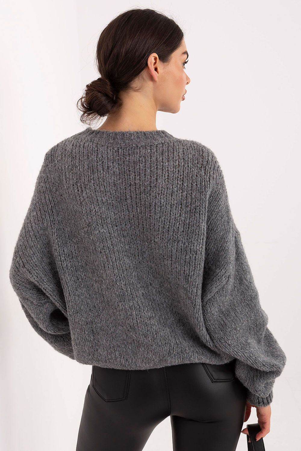 Person wearing a gray sweater from behind on a white background
