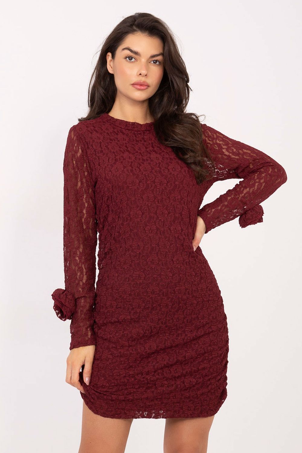 Woman wearing a burgundy lace dress on a white background