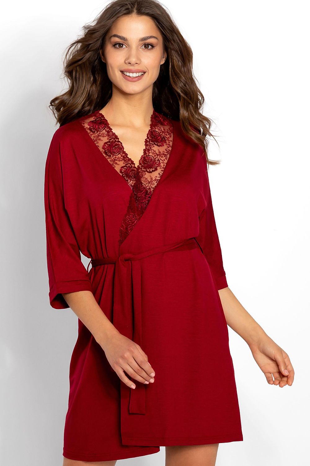 Woman wearing a red robe with lace details on a white background