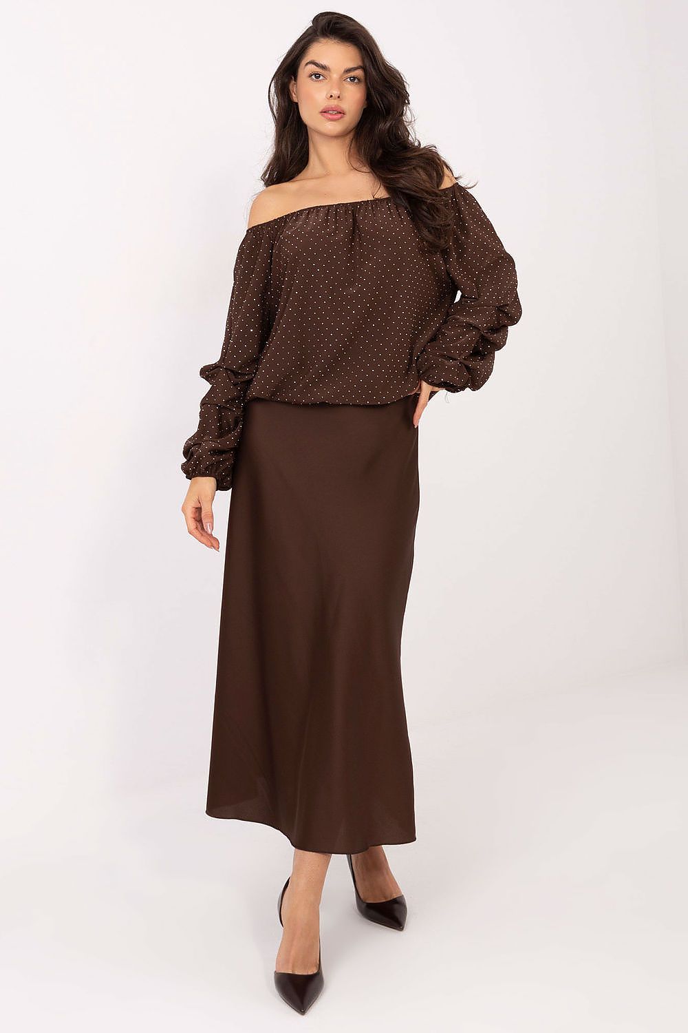 Close-up of brown blouse fabric with jet stones and ruched sleeves