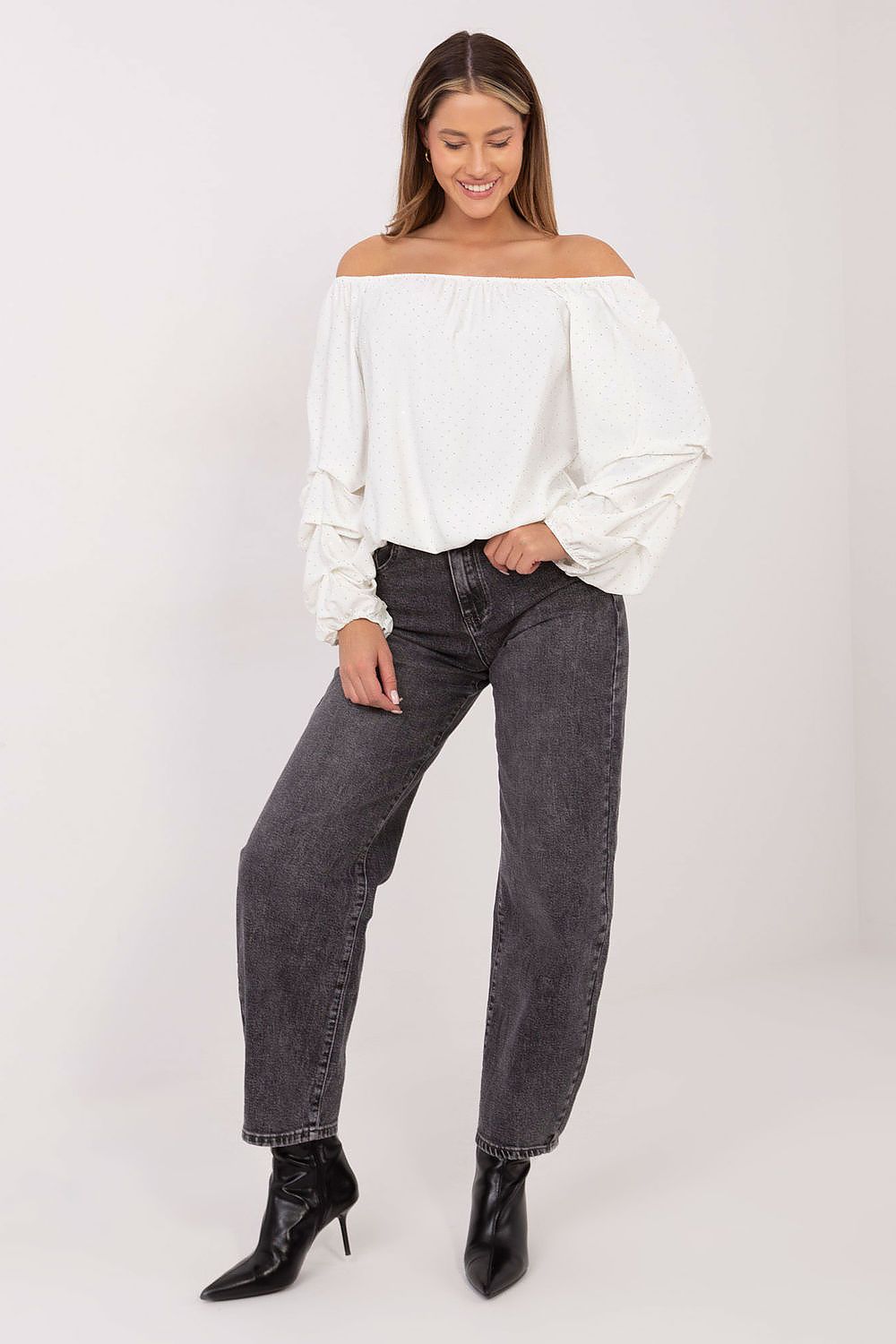 Close-up of beige fabric showing embellishments and ruching