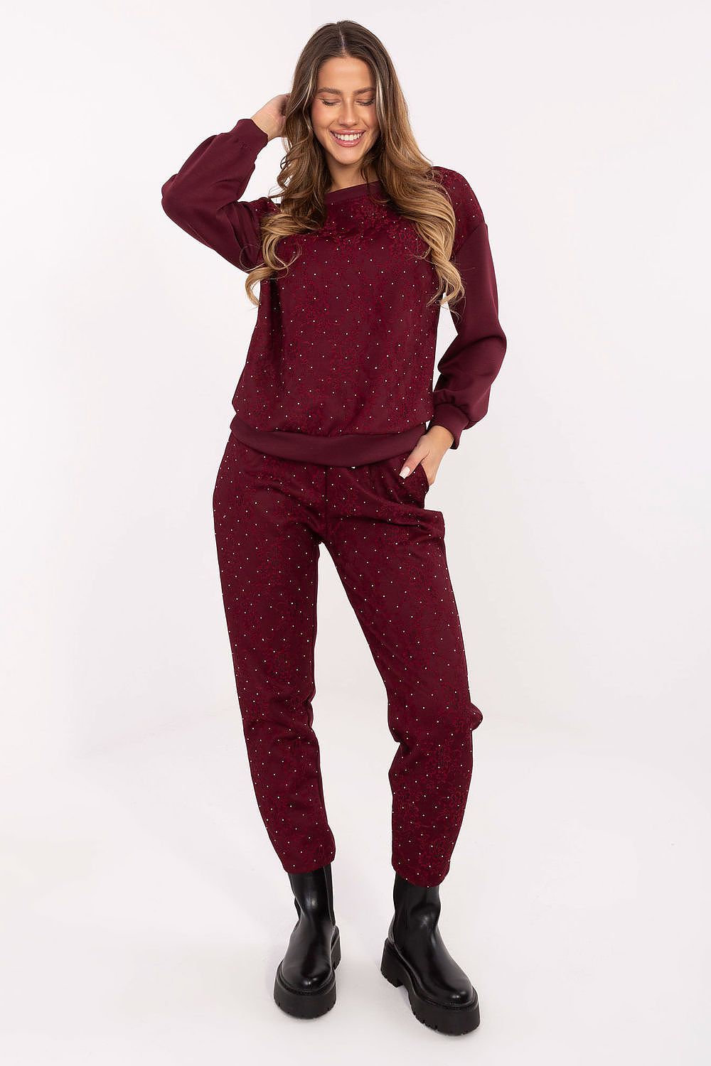 Detail shot of lace and jet embellishments on red tracksuit set