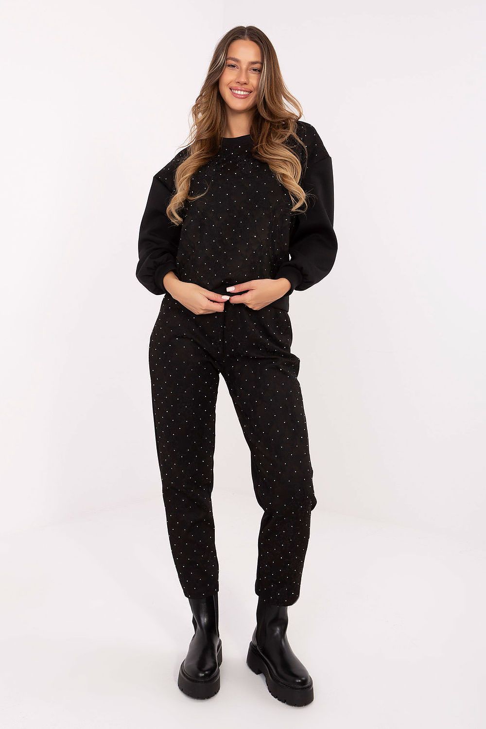 Close-up of lace and jet detailing on black hoodie and pants