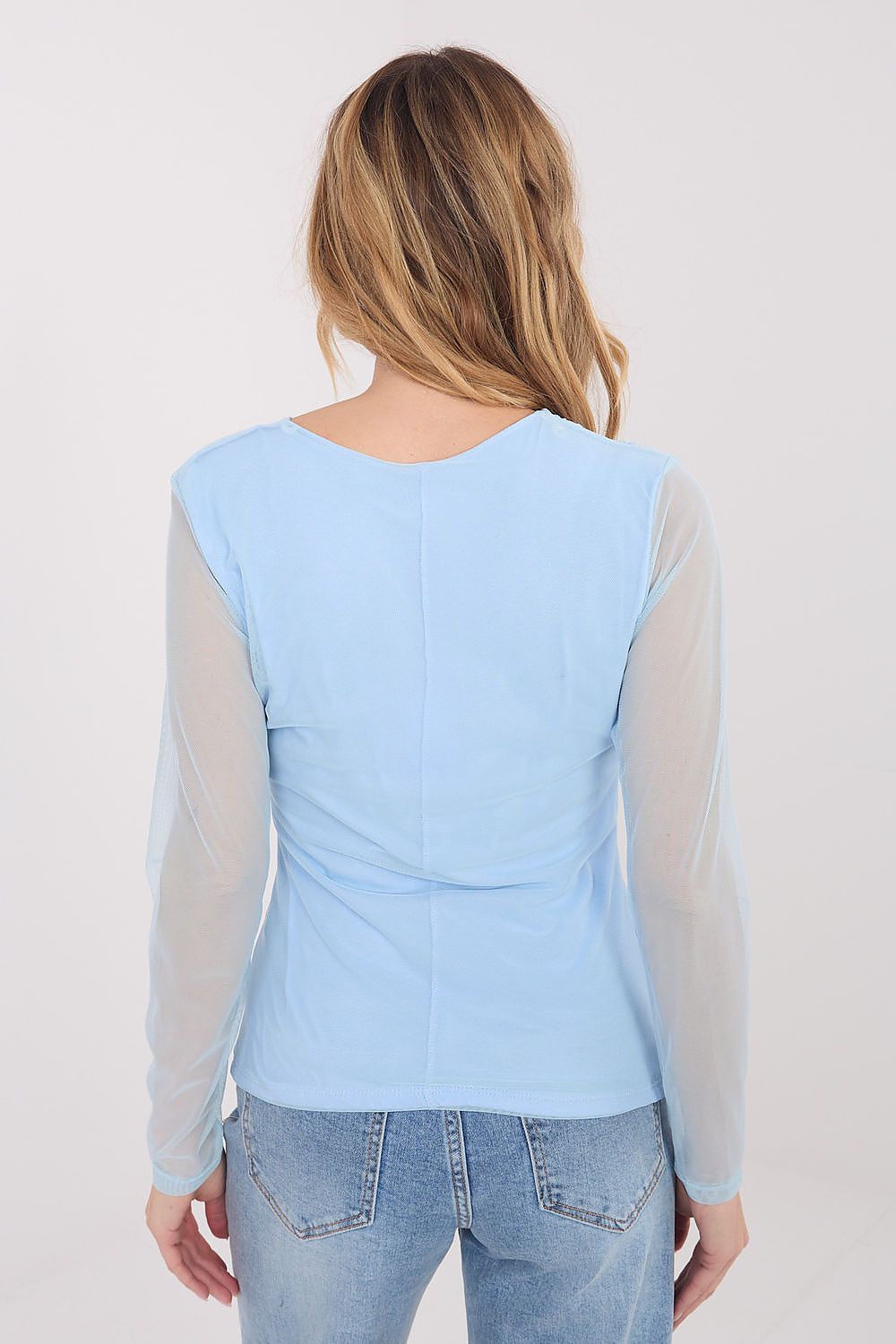 Light blue long-sleeve top with sheer sleeves worn by a person on a plain background