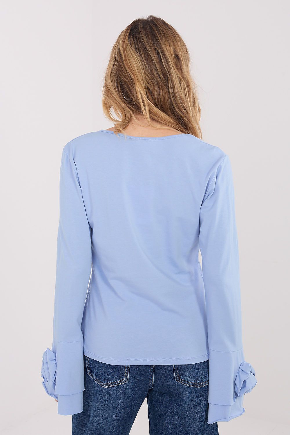 Light blue long-sleeve top worn by a person on a plain background