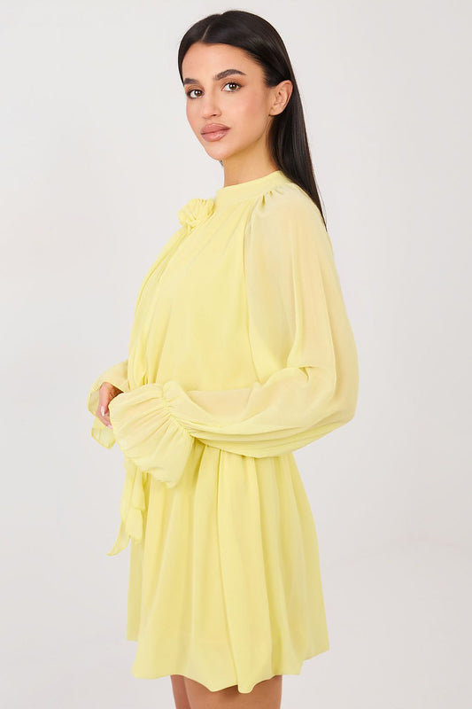 Woman wearing a yellow dress against a white background