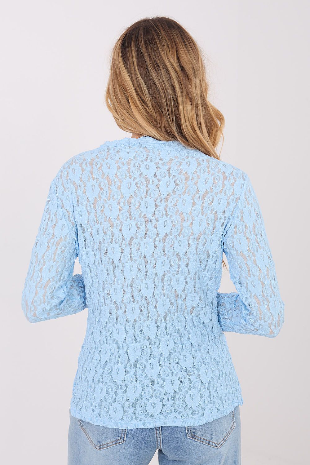 Light blue lace top worn by a person on a plain background