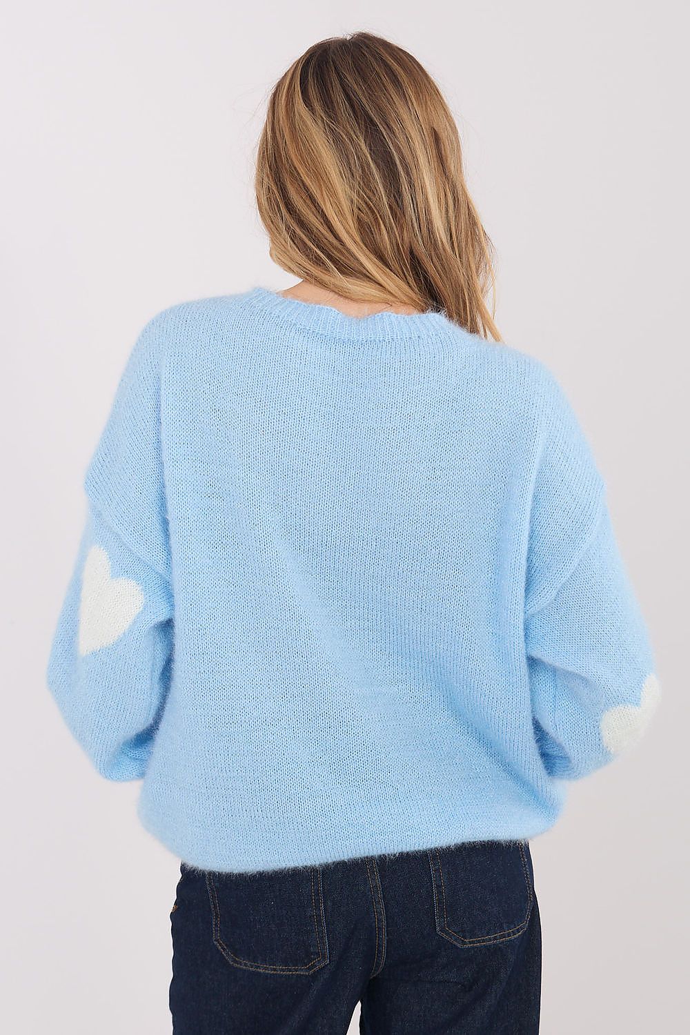 Light blue sweater worn by a person on a plain background