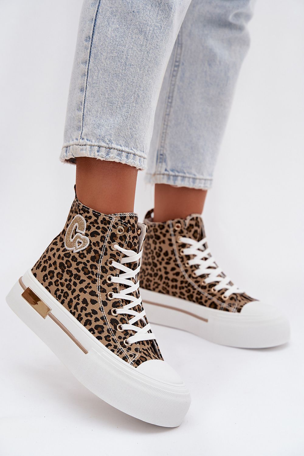 Leopard print high-top sneakers with white soles on a light background