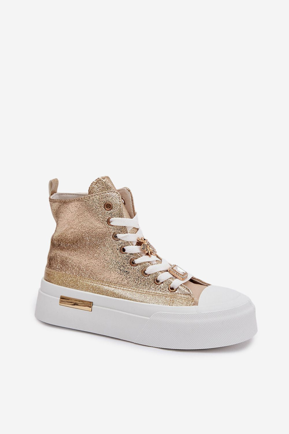Gold high-top sneaker with white laces on a light gray background
