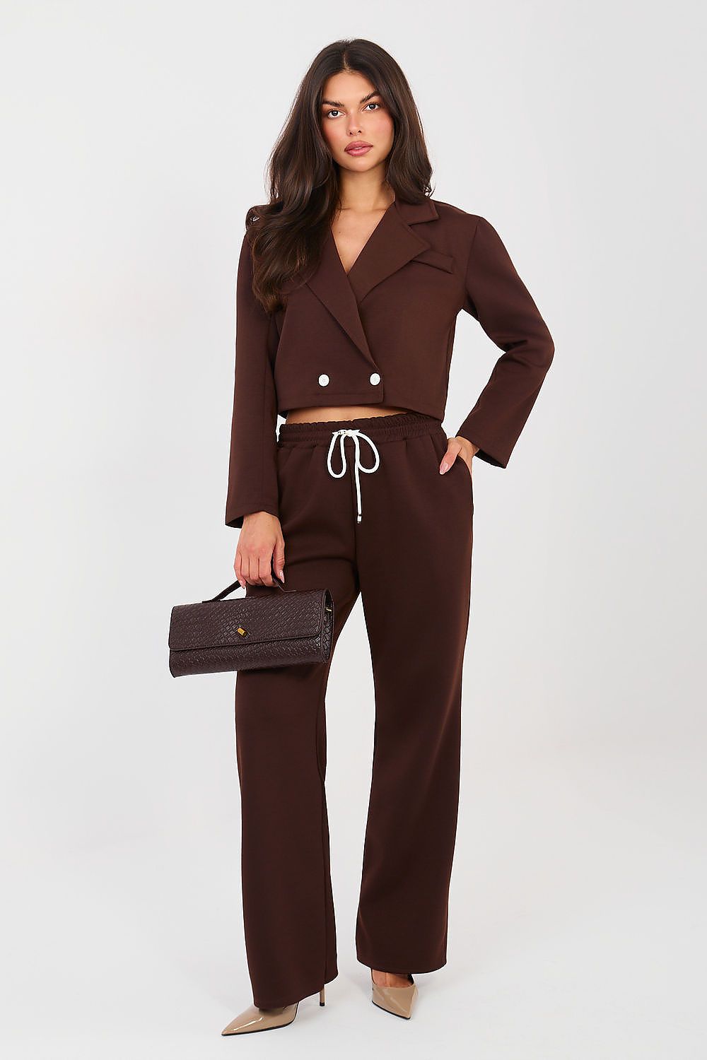 Woman wearing a brown suit with a white background