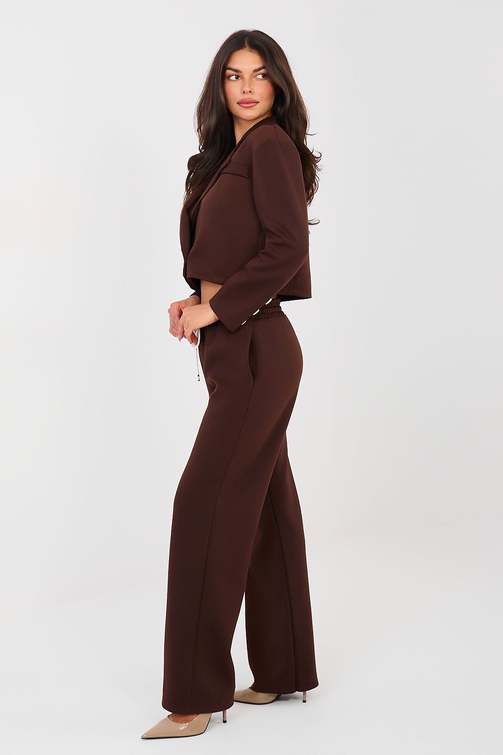 Woman wearing a brown suit on a white background