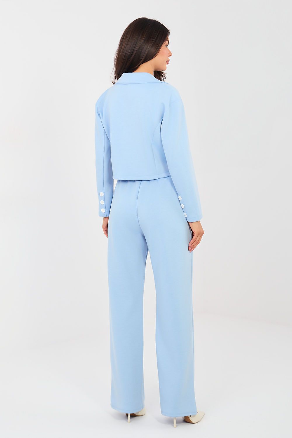 Woman wearing a light blue suit on a white background