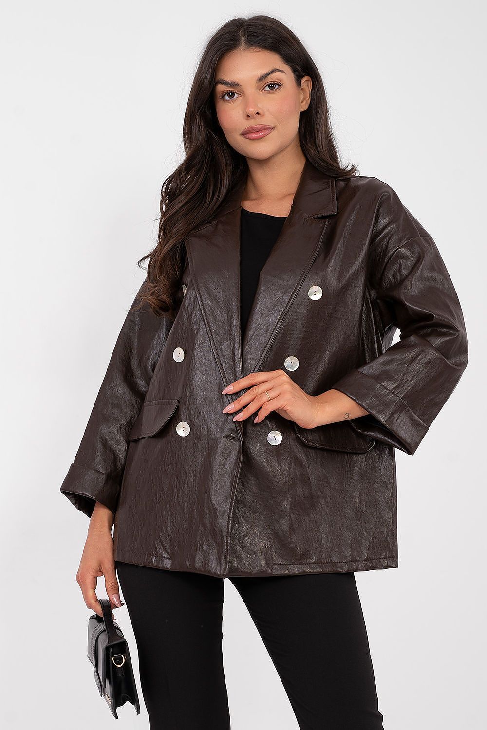 Woman wearing a brown leather jacket on a white background