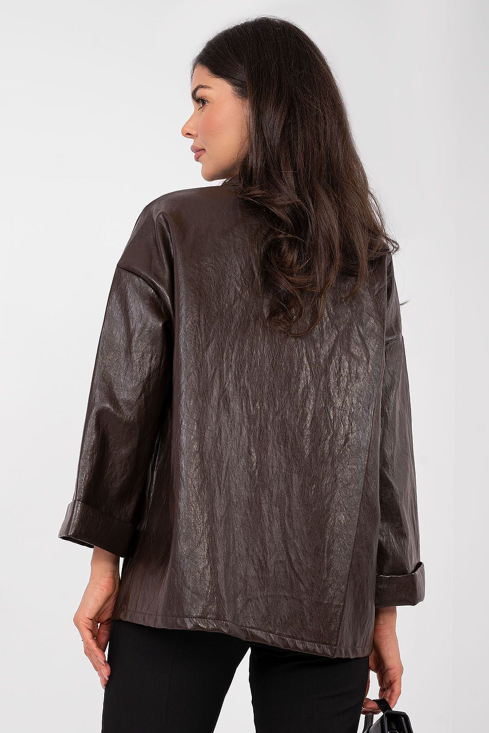 Woman wearing a brown textured jacket on a white background