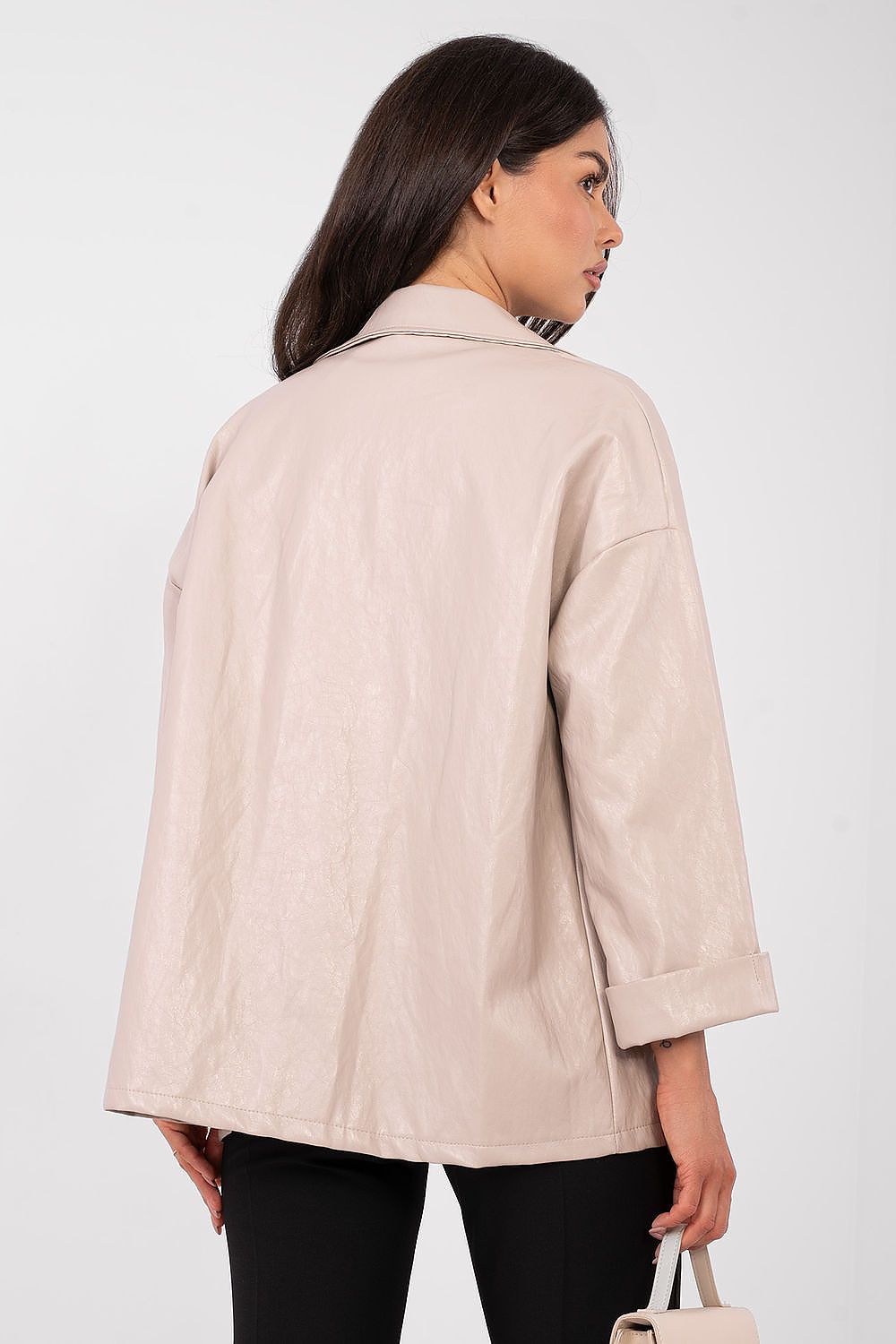 Woman wearing a beige coat against a white background