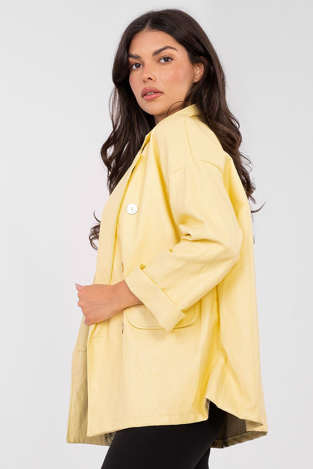 Woman wearing a yellow blazer against a white background