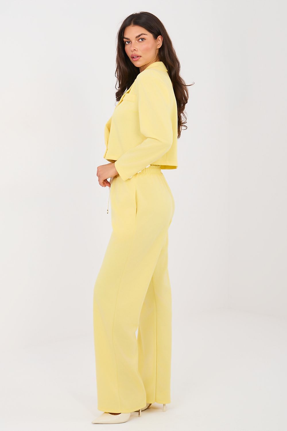 Woman wearing a yellow outfit on a white background