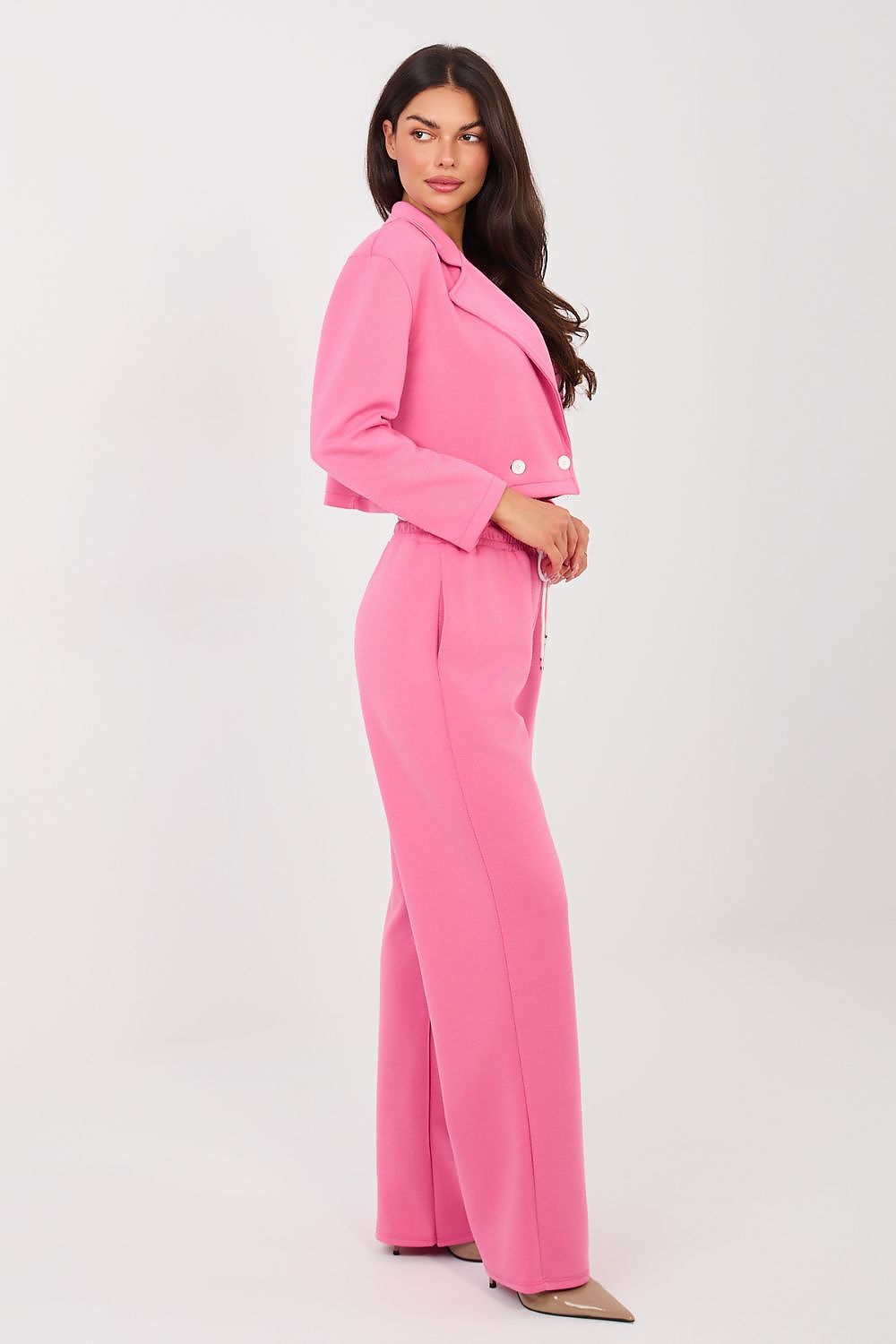 Woman wearing a pink suit on a white background