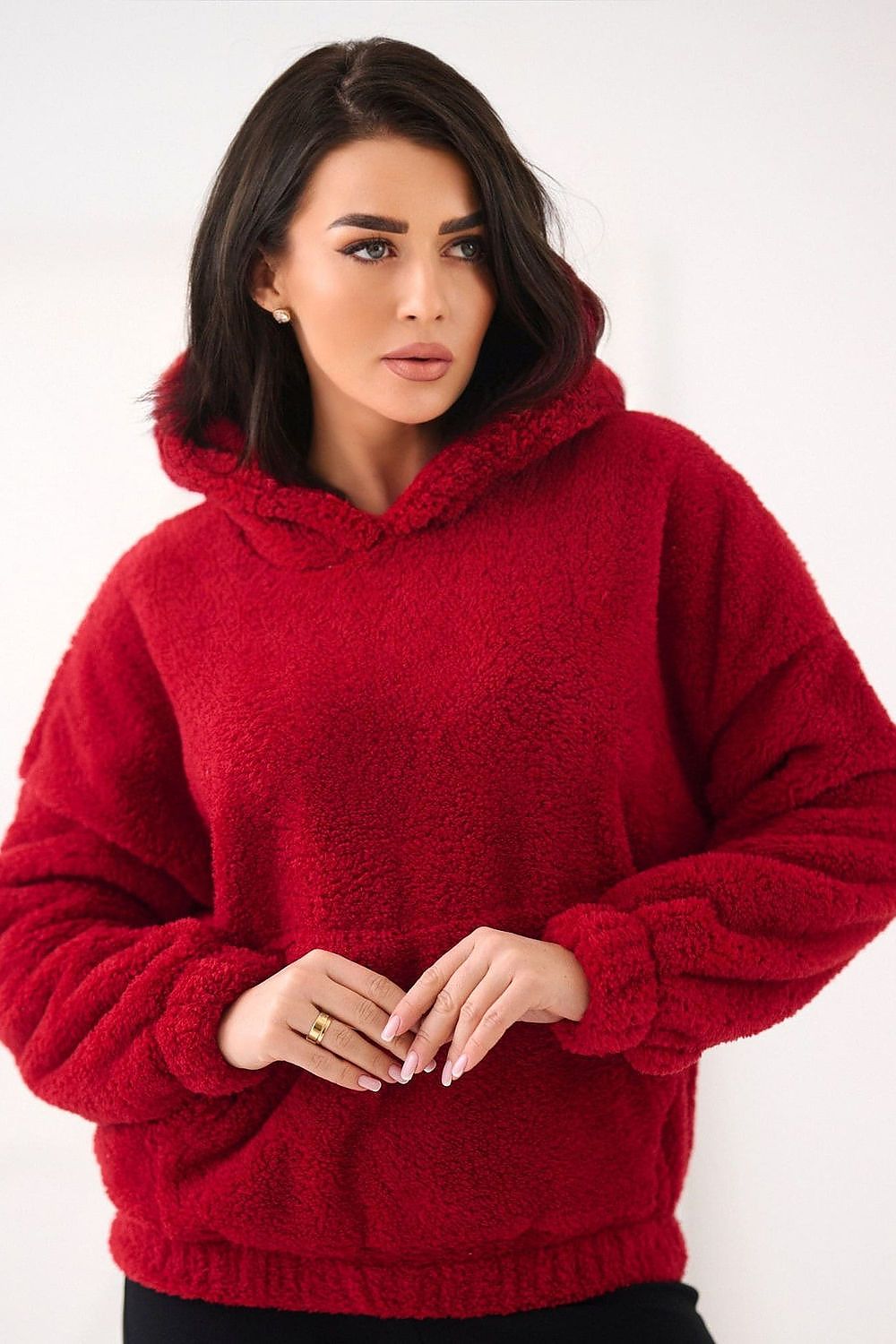 Woman wearing a red hoodie against a white background