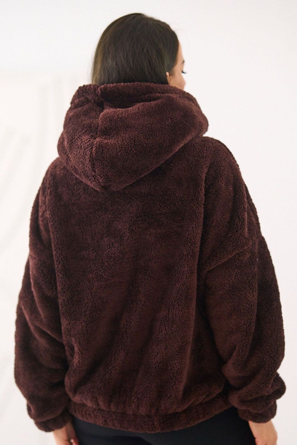 Brown fleece jacket worn by a person on a white background