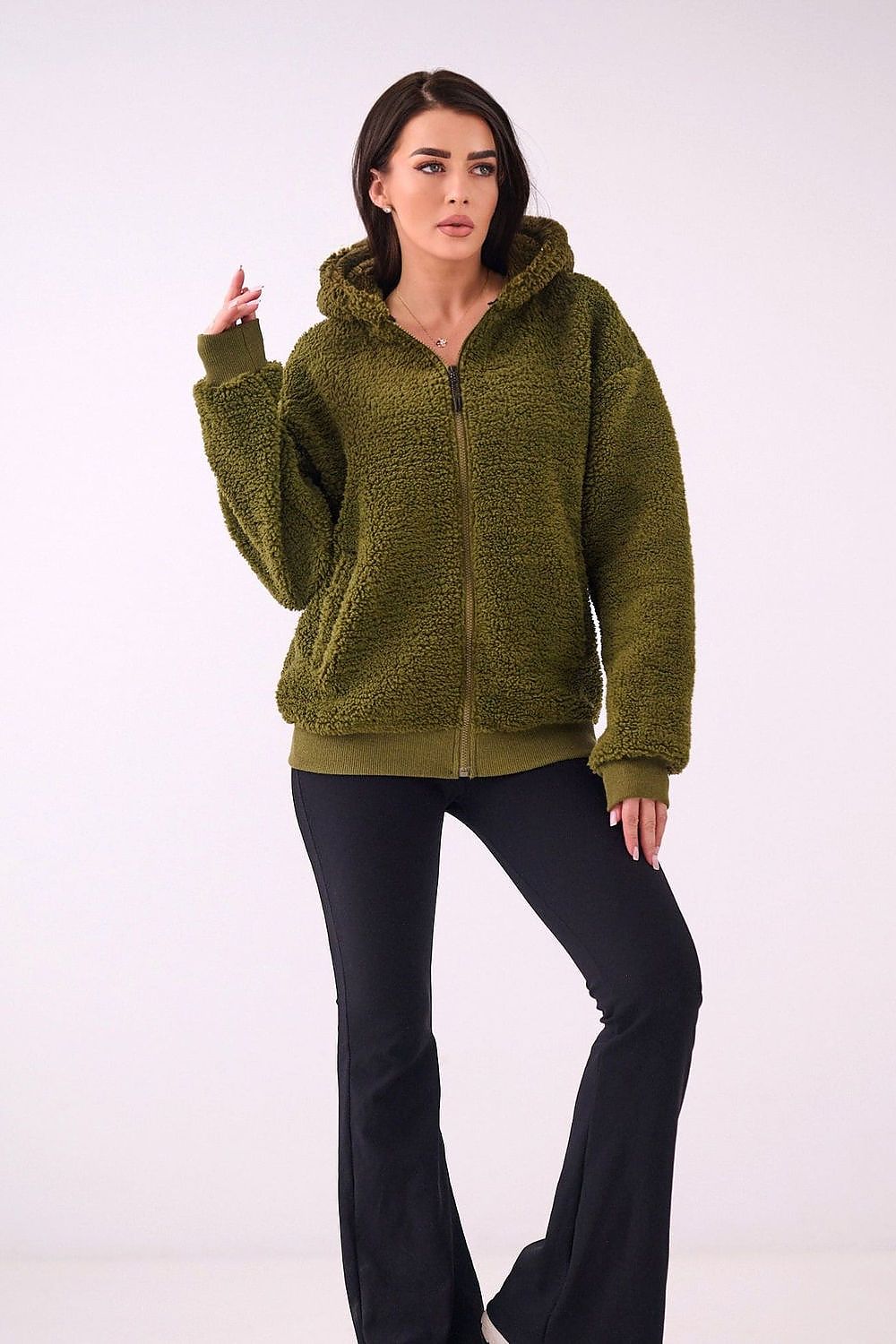 Woman wearing a green knitted hoodie on a white background