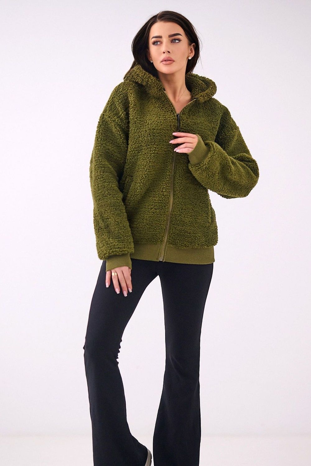 Woman wearing a green fleece jacket on a white background
