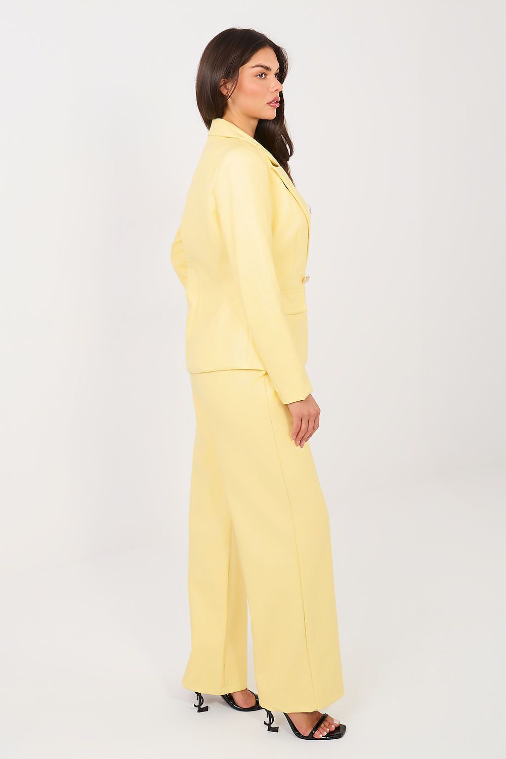 Woman wearing a yellow suit on a white background