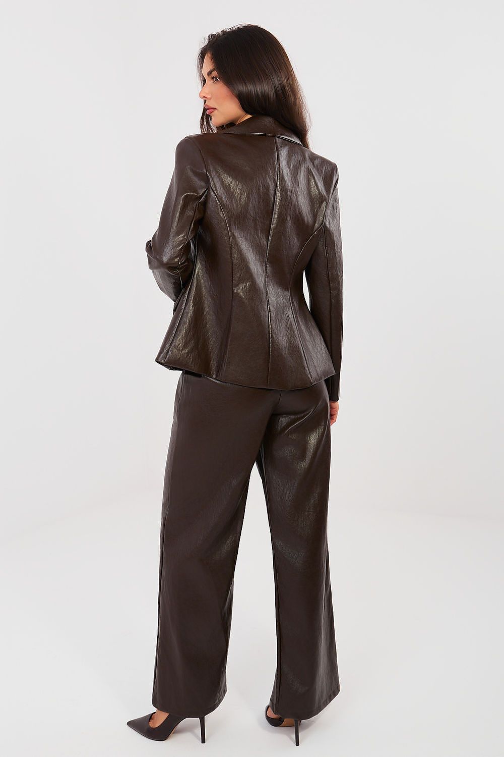 Woman wearing a brown leather suit on a white background