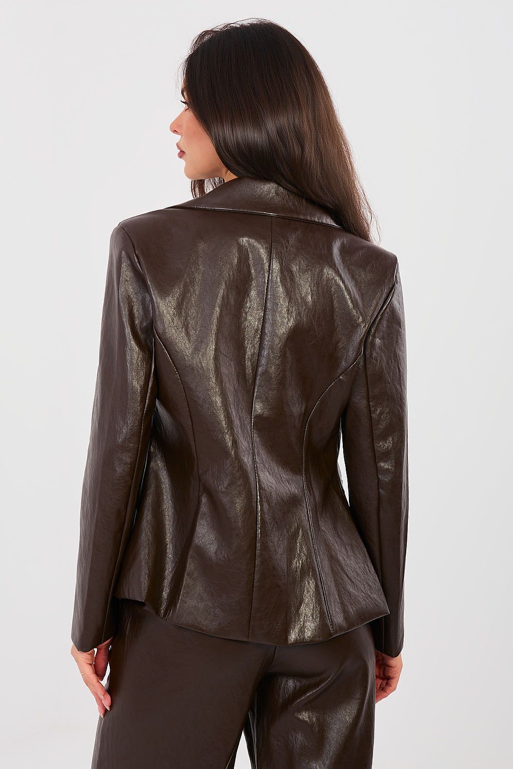 Woman wearing a brown leather jacket on a white background
