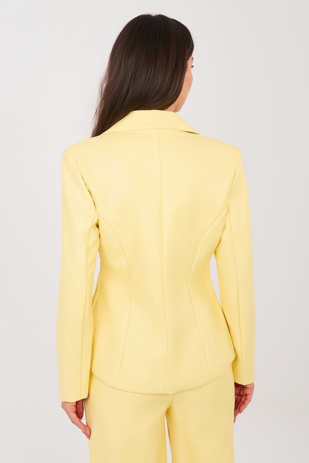 Person wearing a yellow suit on a plain background