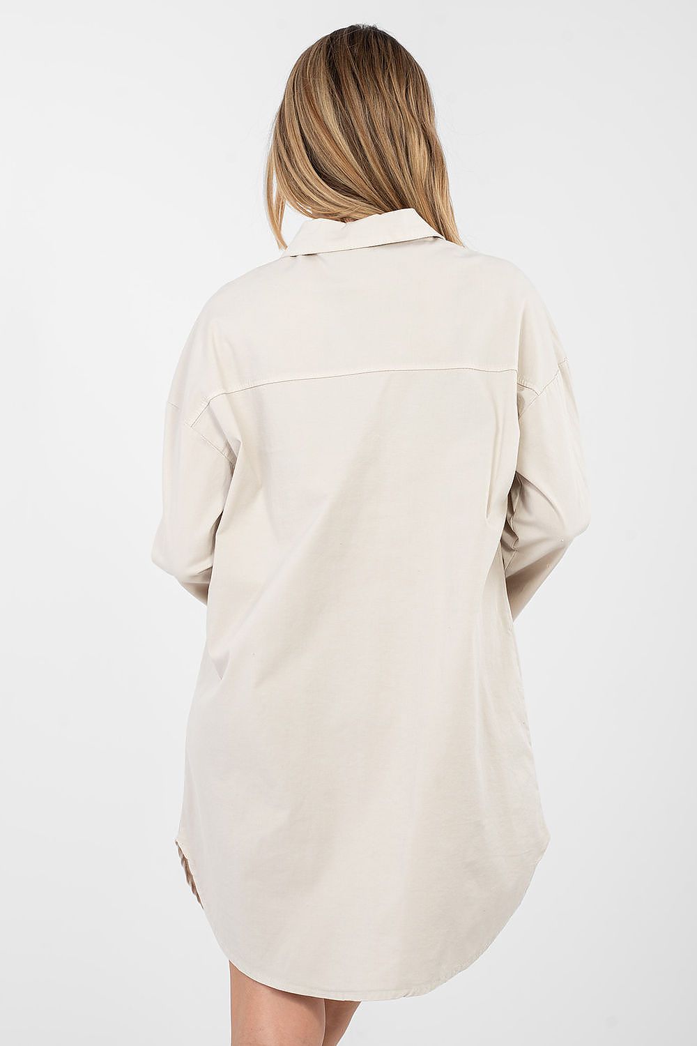 Person wearing a beige shirt on a white background