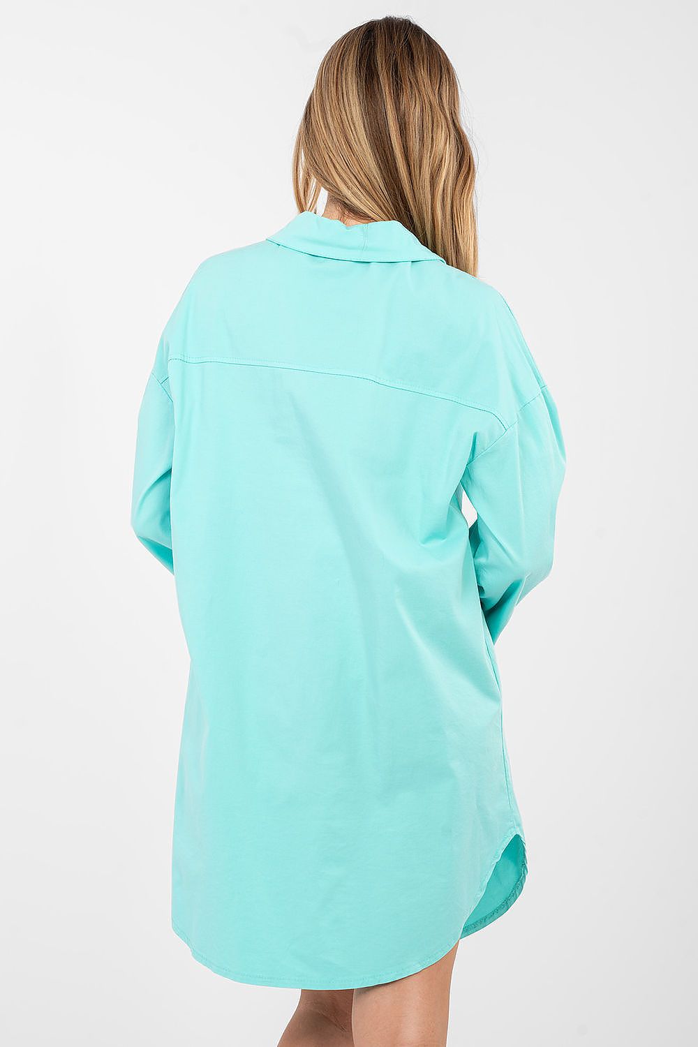 Person wearing a light blue shirt on a white background