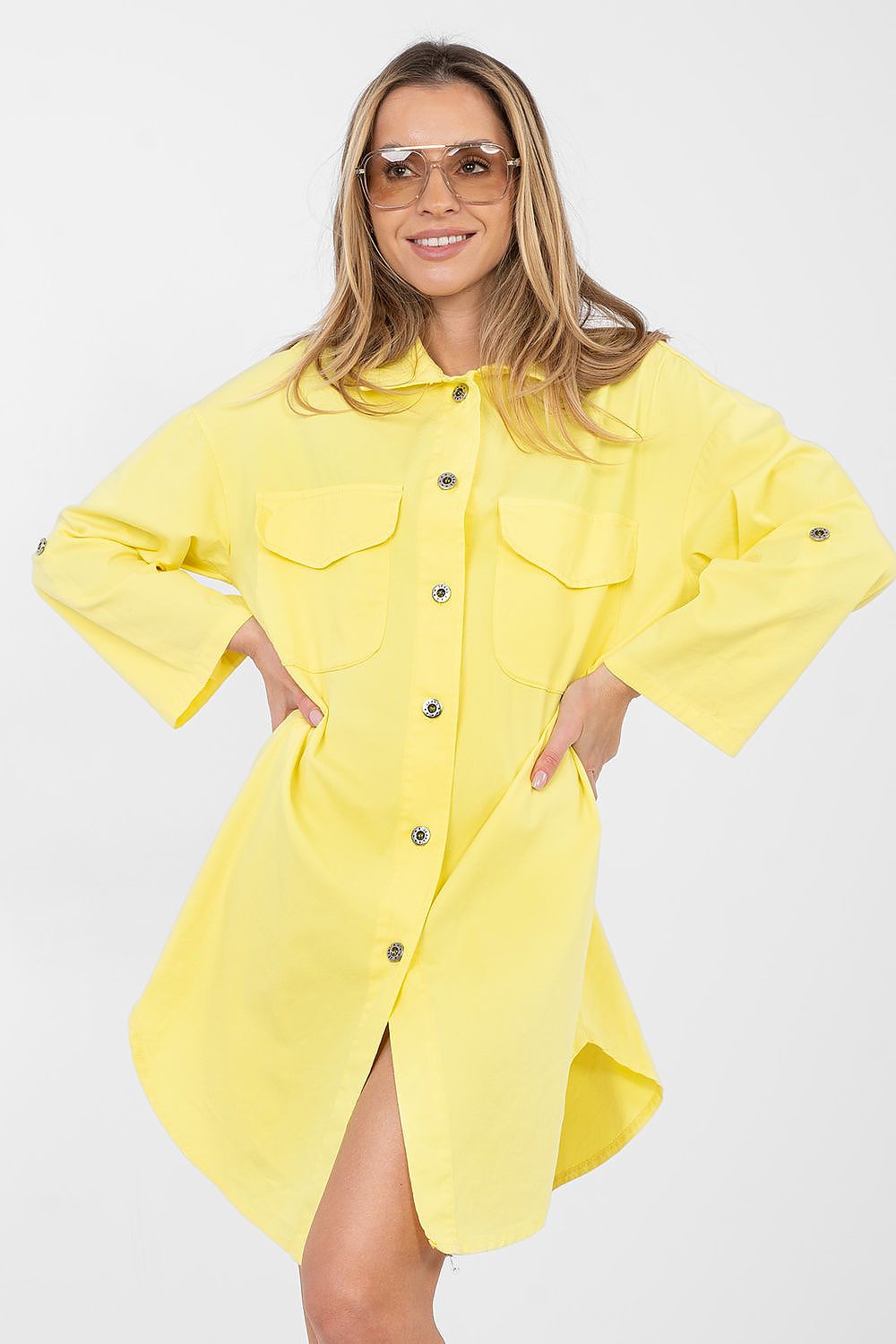 Woman wearing a yellow dress with a white background