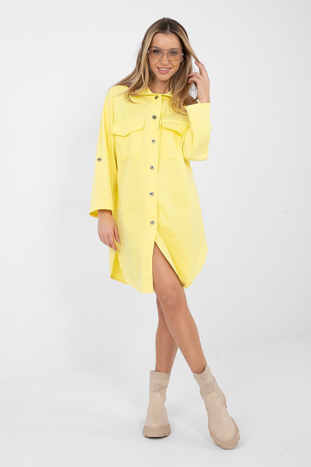 Woman wearing a yellow dress with a white background