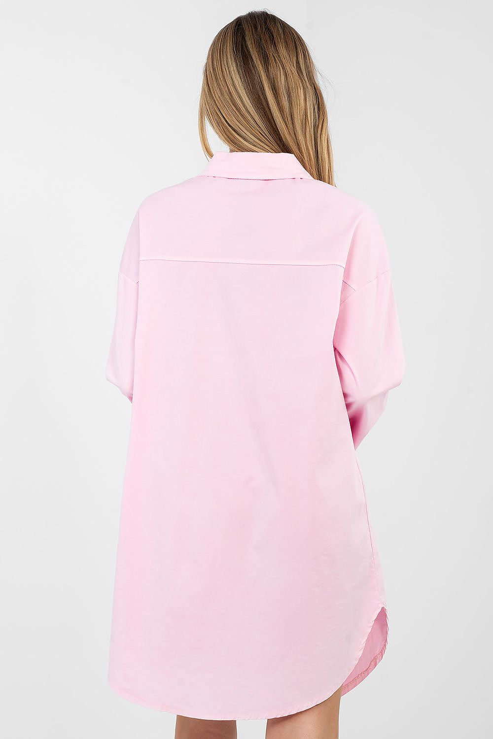 Person wearing a pink shirt on a white background