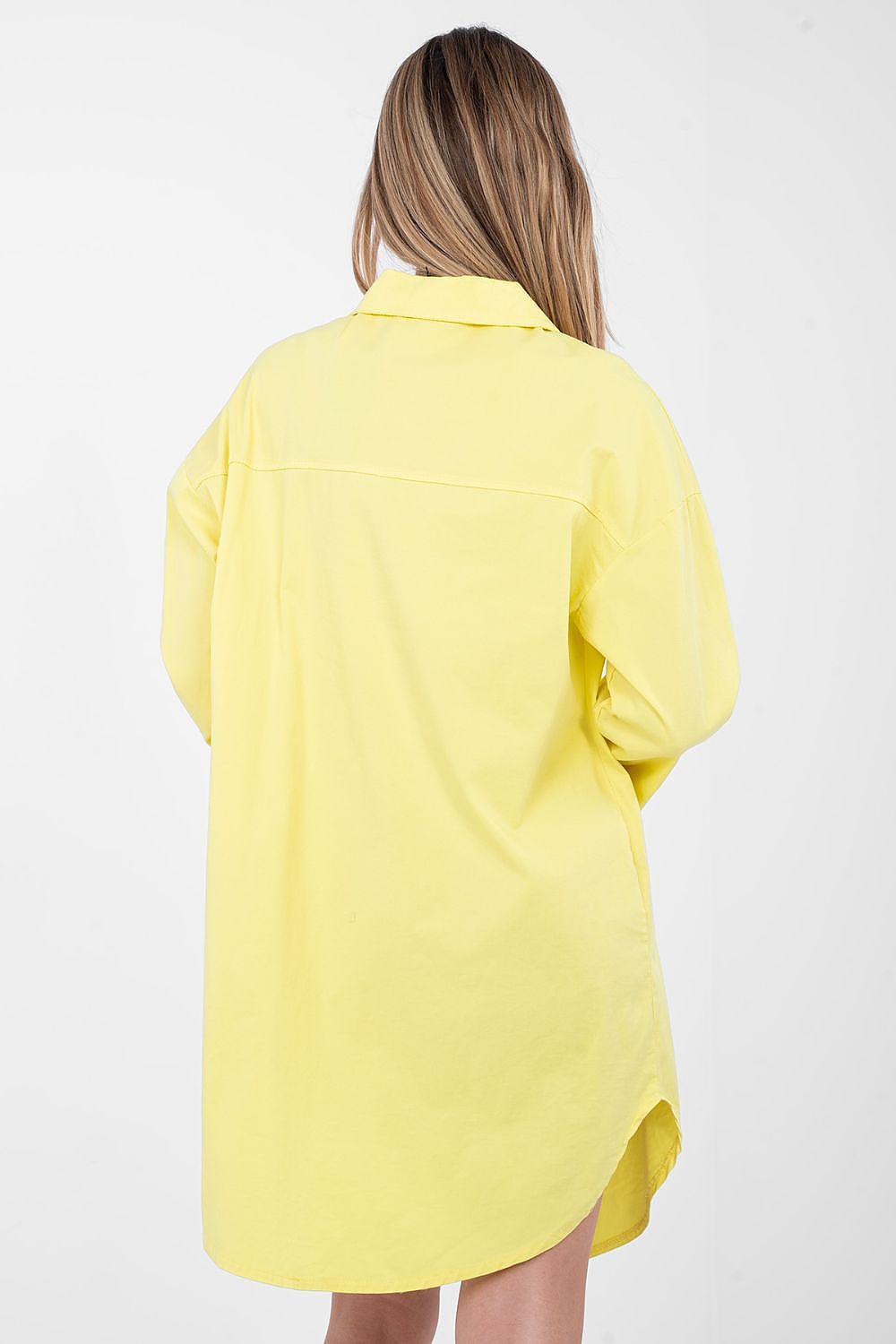 Person wearing a yellow shirt on a white background