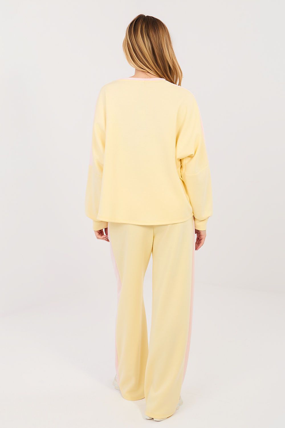 Person wearing a yellow outfit on a white background