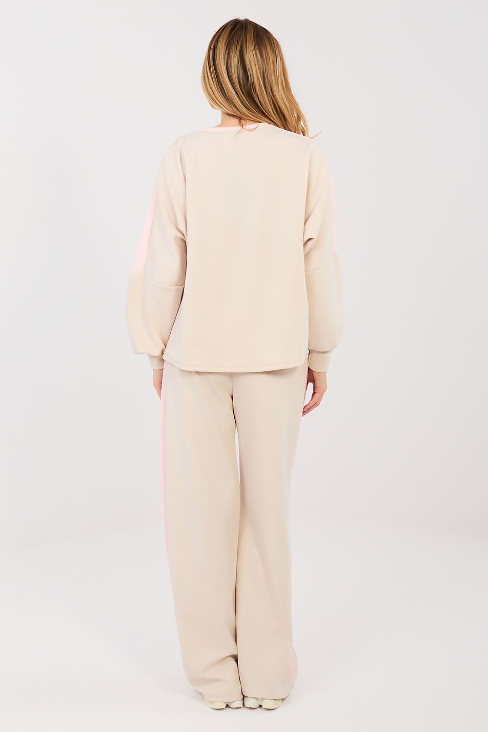 Person wearing a beige suit on a white background