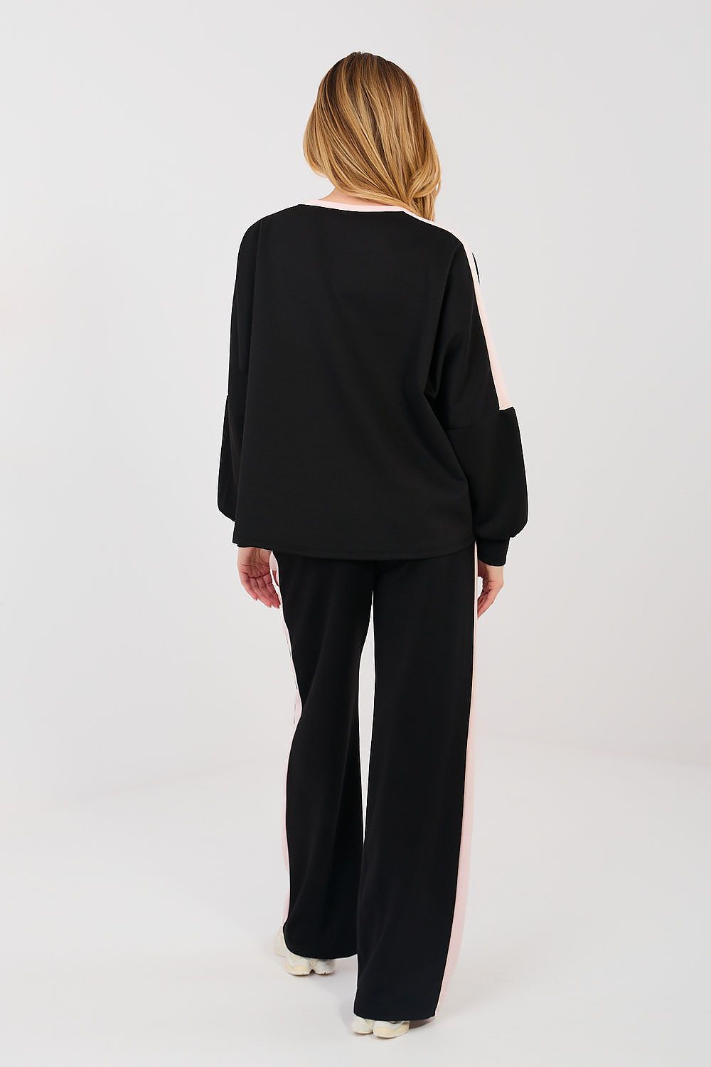 Person wearing a black outfit on a white background