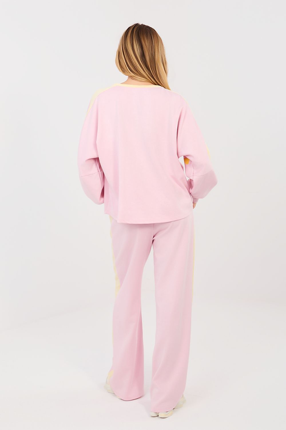 Person wearing a pink outfit on a white background