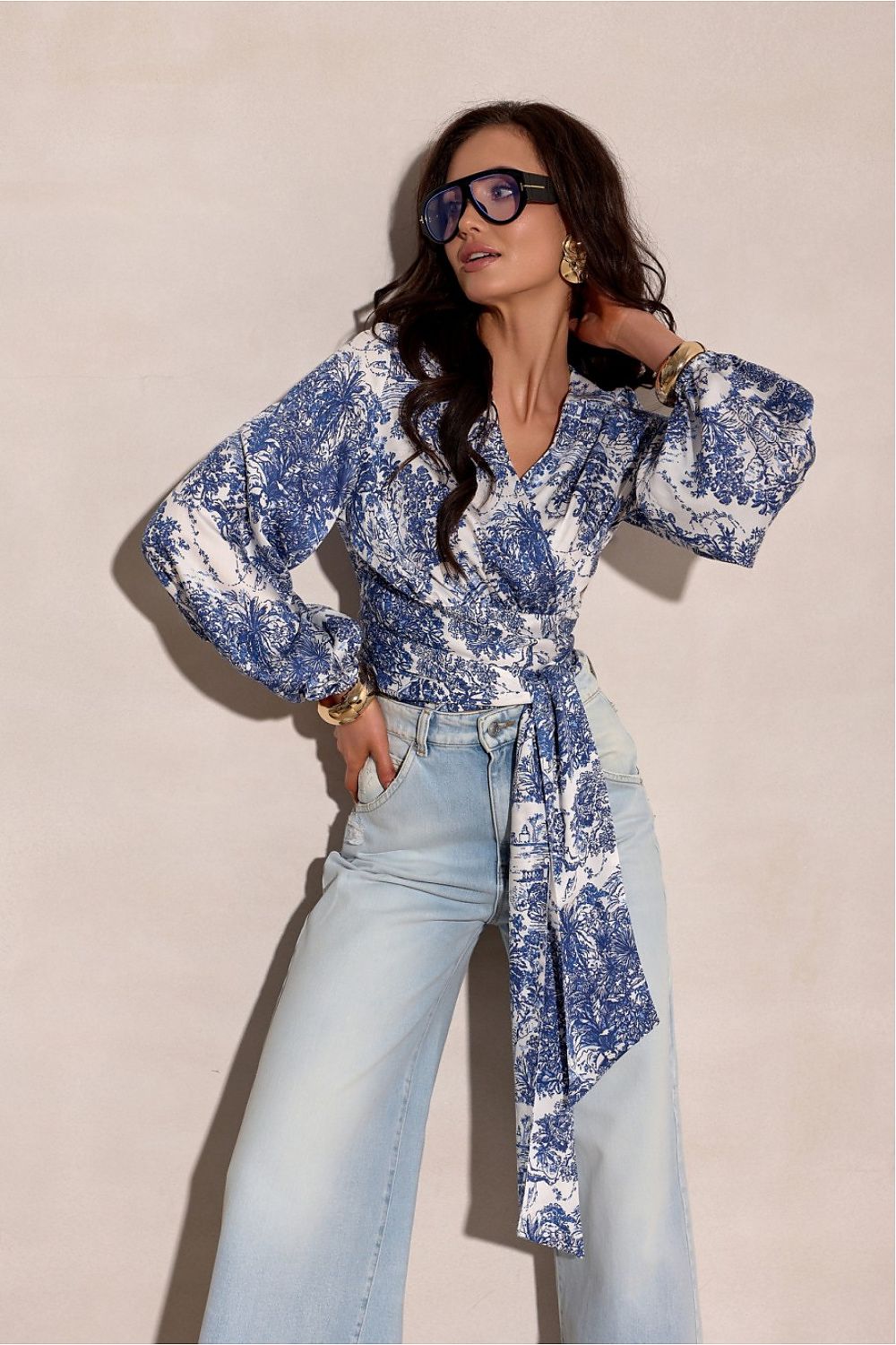 blue wrap blouse with waist tie and decorative pattern