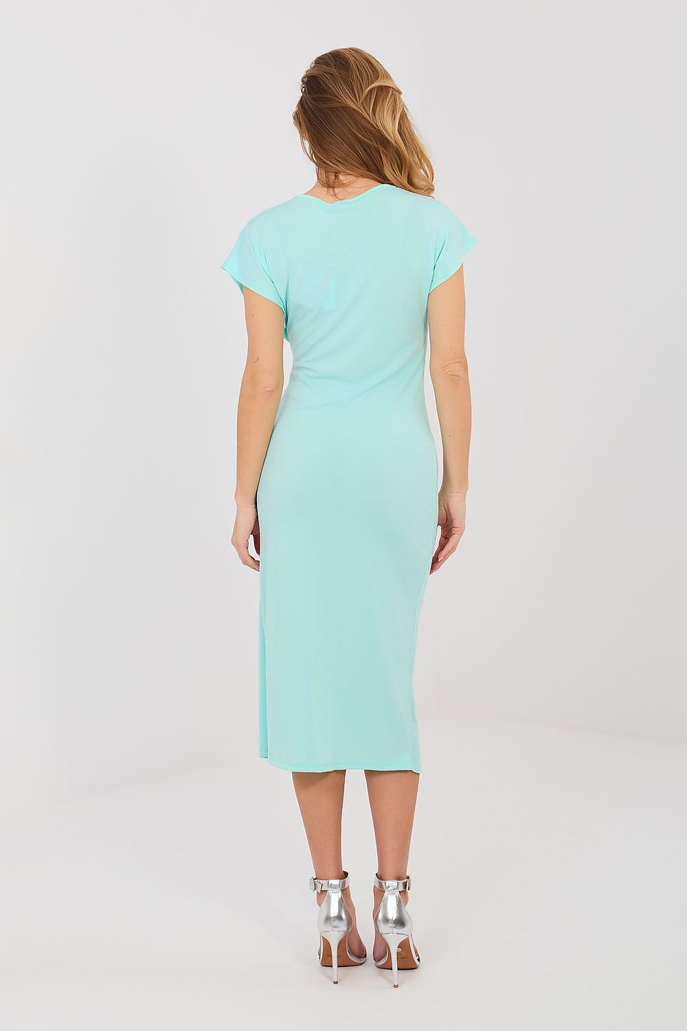 Woman wearing a light blue dress on a white background