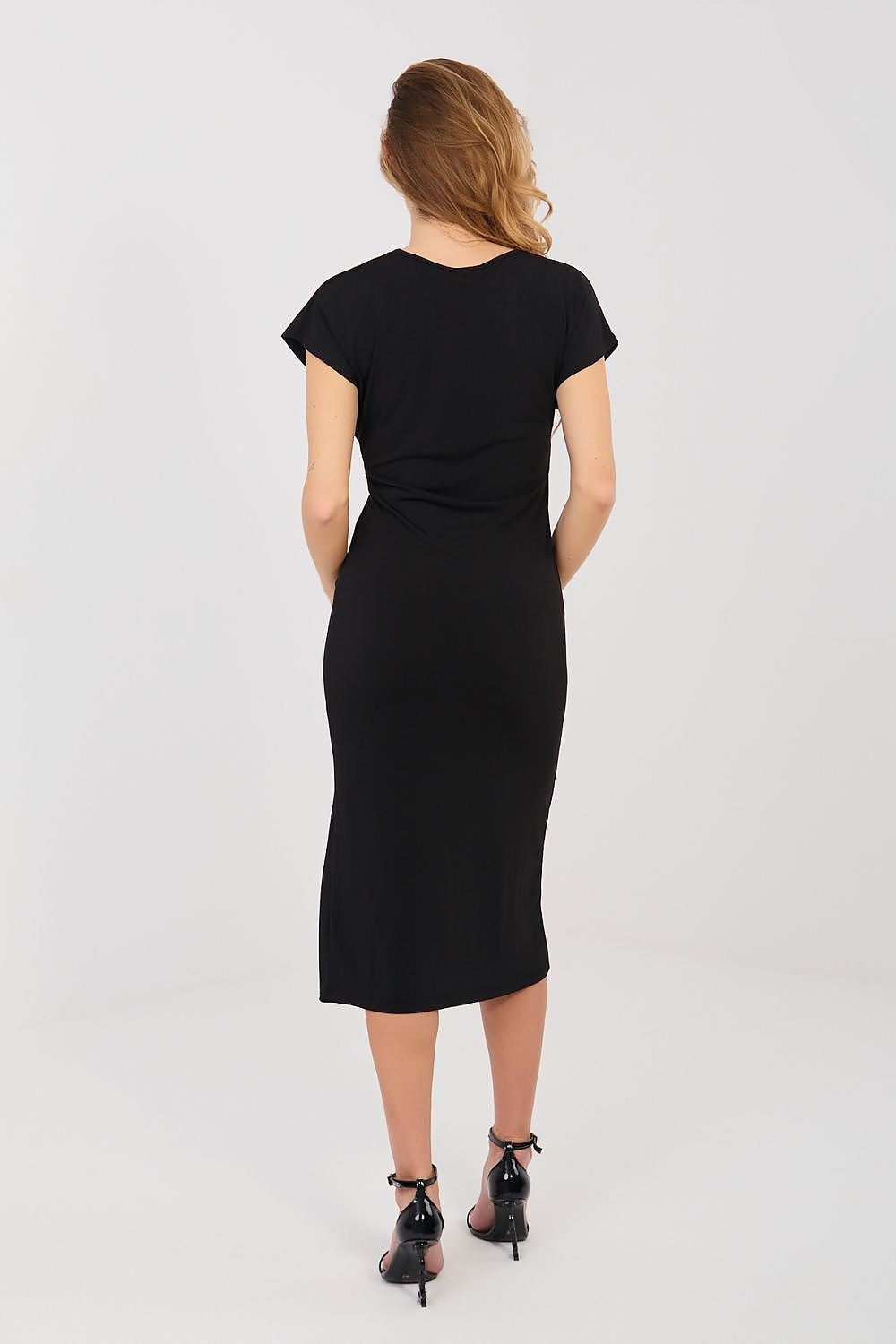 Woman wearing a black dress on a white background