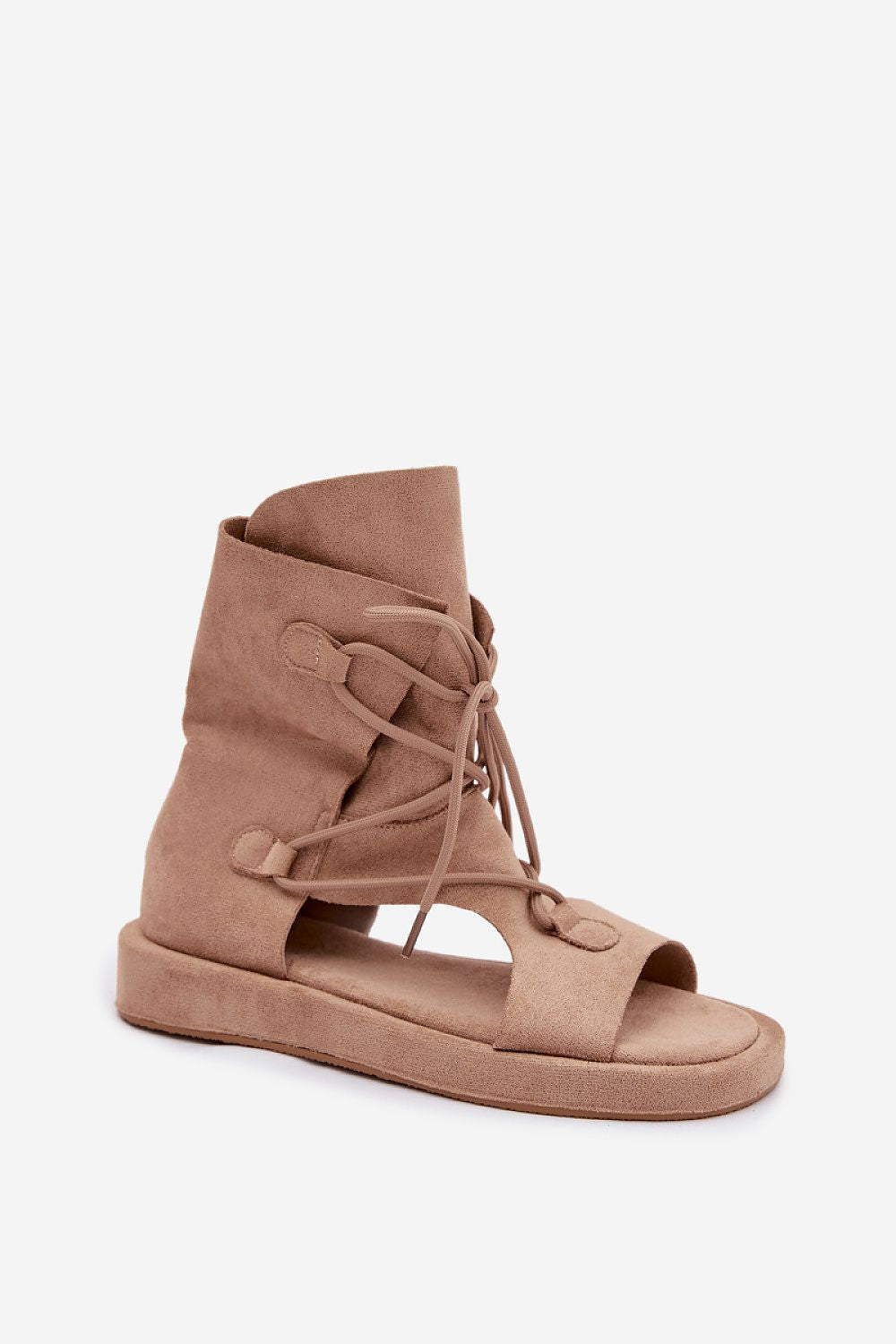 Tan suede sandal with lace-up design on a white background