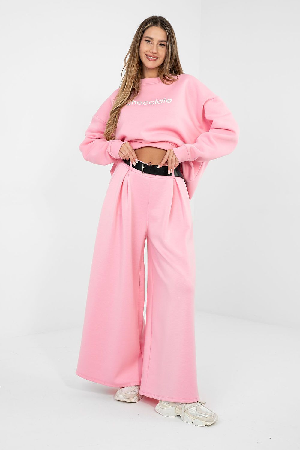 Woman wearing a pink outfit with a white background