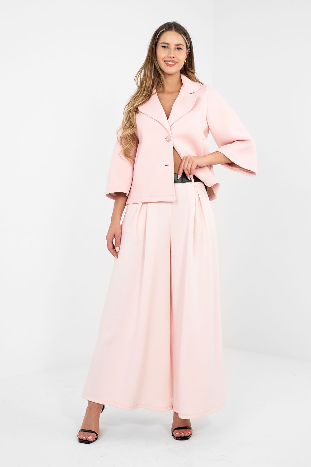 Woman wearing a pink outfit on a white background