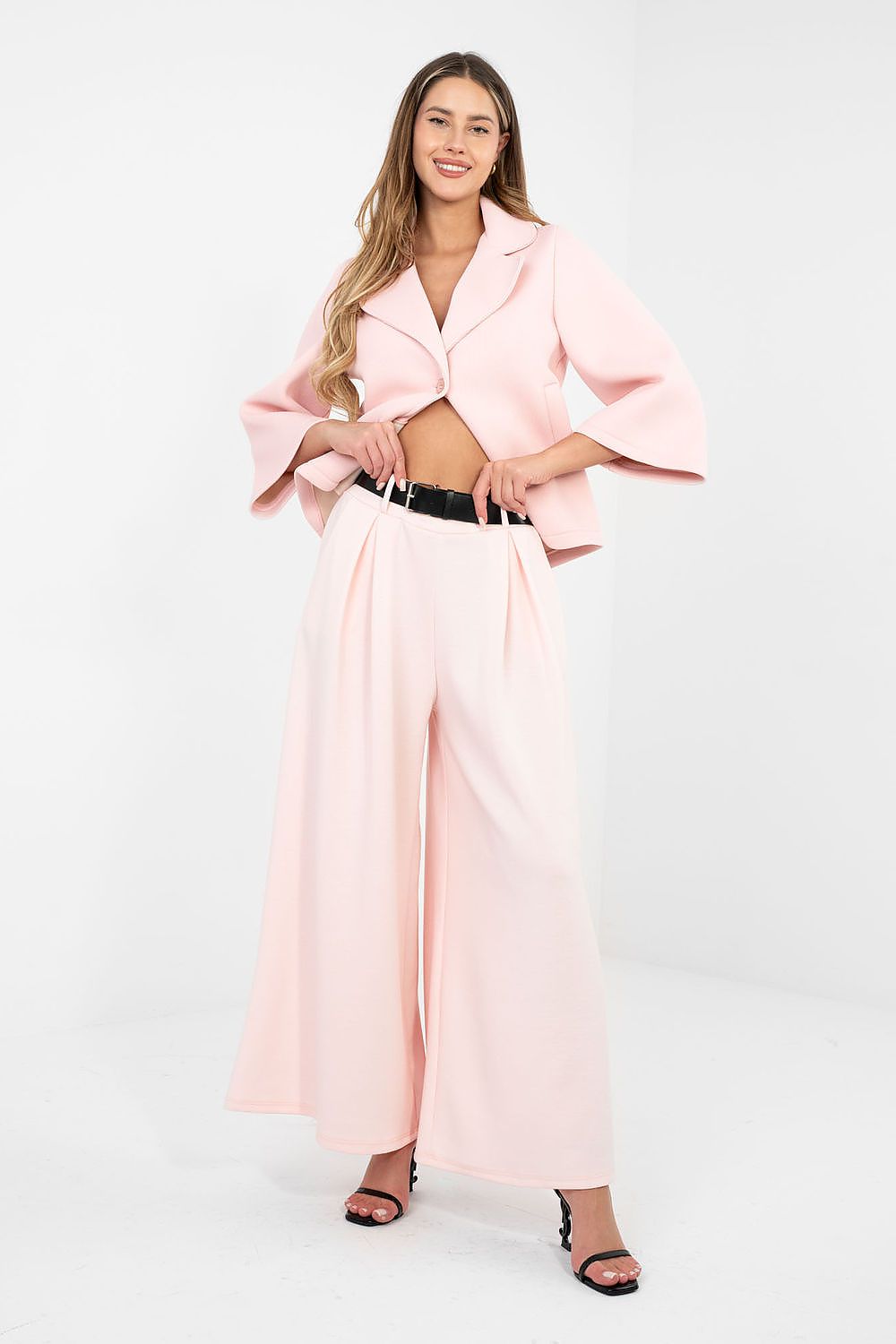 Woman wearing a pink outfit with a white background